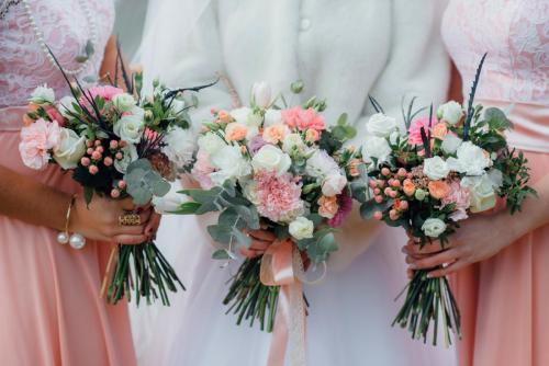 Wedding flowers in hand the bride and her bridesmaids.